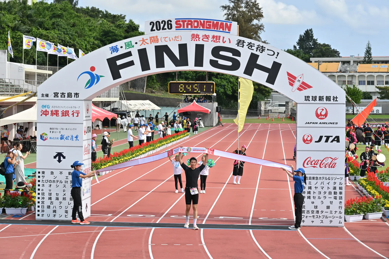Crossing the finish line with the clock at 8:45
